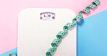 Eine Waage mit einem Maßband